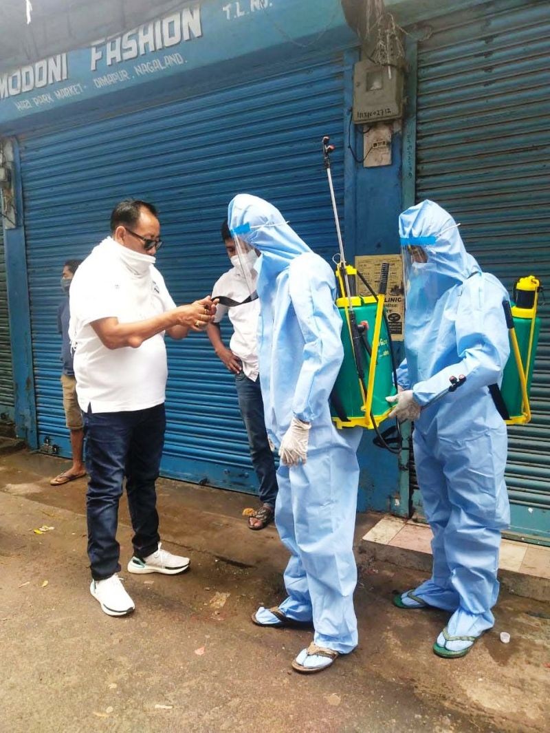 A member of Hazi Park Business Welfare Committee assists the workers to sanitize Hazi Park (Hongkong Market), Dimapur on June 16. (Photo Courtesy: HPBWC)